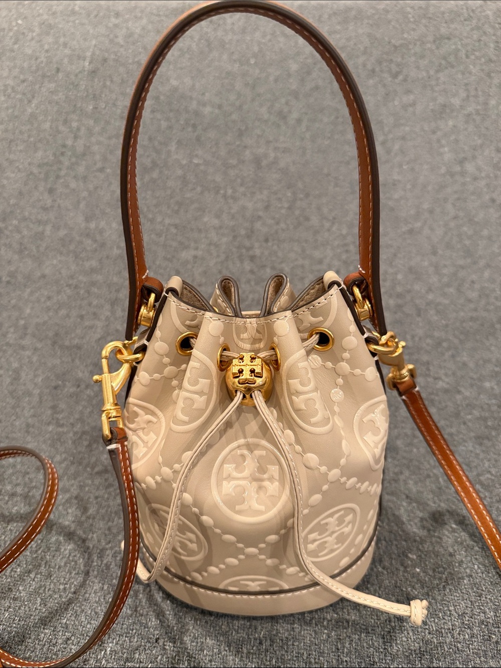Tory Burch Beige Embossed Monogram Mini Bucket Bag